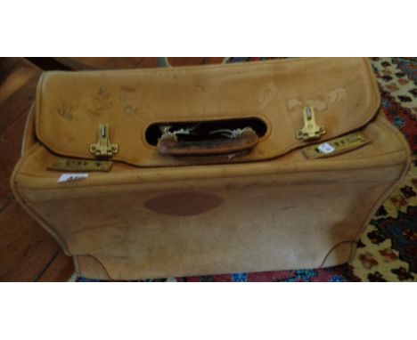 An airline pilot's light tan leather bag