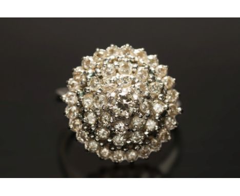 An 18ct white gold and diamond mounted circular target cluster ring: with tiers of brilliant-cut diamonds estimated to weigh 