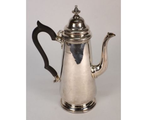 A George V silver coffee pot, maker HEB.FEB, Chester, 1911: in the Georgian taste, with domed hinged lid with urn finial, of 