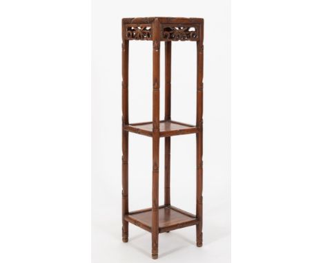 A Chinese carved hardwood square three-tier stand:, with pierced foliate scroll friezes and rounded uprights, 25cm (9 3/4in) 