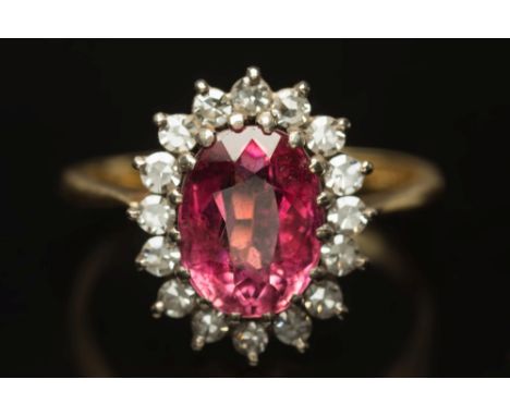 An 18ct gold, pink tourmaline and diamond oval cluster ring:, ring size 'Q 1/2'.