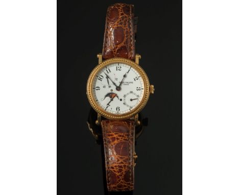 Patek Philippe. A gentleman's 18ct gold Patek Philippe wristwatch: with complications, model 5015J, the circular white enamel