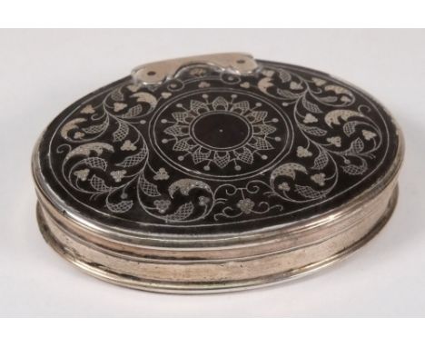 A late 18th century oval tortoiseshell and silver mounted snuff box, unmarked: the hinged oval top with foliate and scroll in