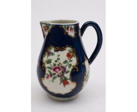 A First Period Worcester scale blue ground sparrow beak milk jug: with plain loop handle, decorated with gilt cartouches of E