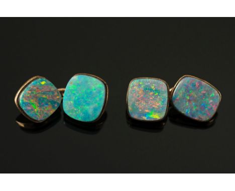 A pair of opal doublet mounted cuff-links:, each panel with a cushion-shaped opal doublet.