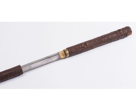 A Japanese sword stick: with 59cm. fullered blade having an indistinctly signed tang, contained in a simulated wood sheath, 9