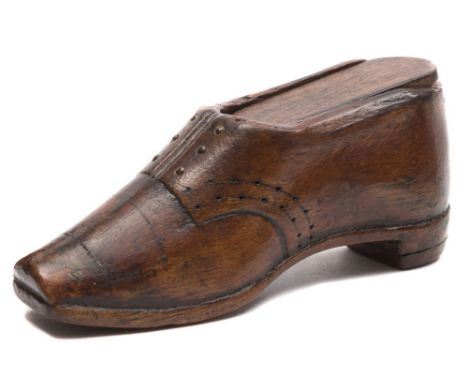 A 19th century treen snuff box in the form of a shoe: with sliding cover and inlaid steel pin decoration, 10.5cm. long.

