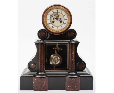 A Victorian French black marble mantel clock: the eight-day duration movement striking the hours and half-hours on a bell wit