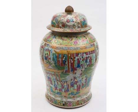 A large Canton famille rose vase and cover: of baluster form, the domed cover with bud finial, painted overall with figures i