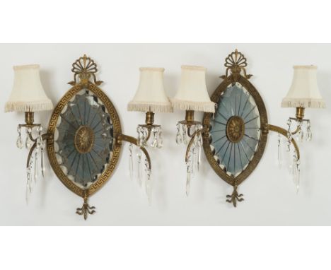 A pair of Regency-style gilt-brass girandoles: each of elliptical form with mirrored plate, Greek key pattern frame and anthe