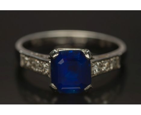 A platinum and sapphire single-stone ring: with 'emerald-cut' sapphire approximately 7mm x 6.3mm x 4.2mm deep, estimated to w