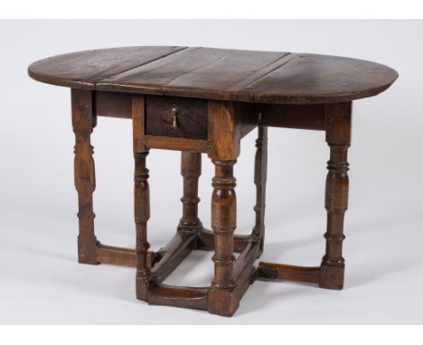 A 17th Century and later oak gateleg table:, the hinged top with D shaped leaves, on split ring turned legs, united by plain 