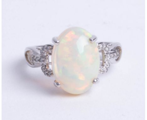 An 14ct opal and diamond ring, size N.