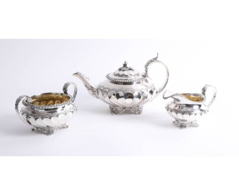 A Will IV three piece silver tea service of squat design with fluted body, teapot hallmarked circa 1834 makers mark 'WH' poss