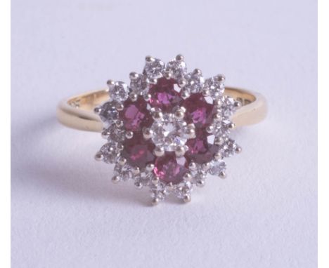 An 18ct ruby and diamond cluster ring, size P.