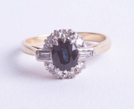 A small 18ct sapphire and diamond cluster set with a round cut and baguette cut diamonds, ring size K.