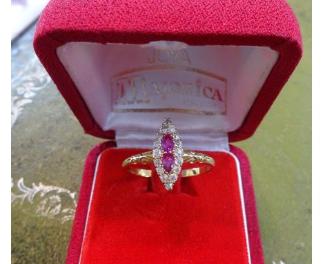 An 18ct ruby and diamond marquise set ring, size W.