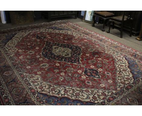 Early/mid-20th century Persian style wool carpet (worn), featuring geometric and floral patterns in blue, beige and red to a 