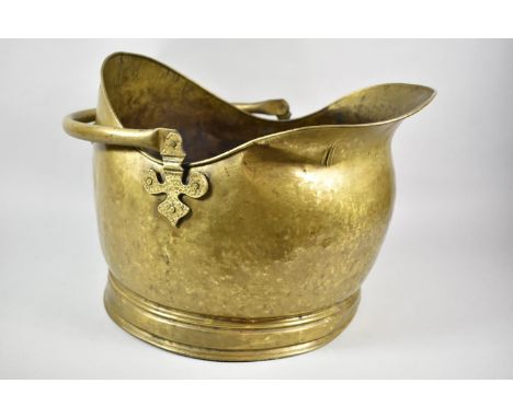 A Brass Helmet Shaped Coal Scuttle, 44cm Long 