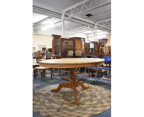 A Stripped Pine Circular Breakfast Table on Tripod Support, 136cm Diameter 