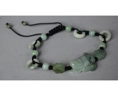 A Souvenir Jade and Cord Bracelet with Laughing Buddha Mount 