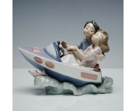 Delightful  porcelain figurine depicting a romantic scene of a young couple enjoying a tranquil moment on the water as they c