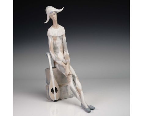 A striking blend of drama and serenity, this porcelain figurine by Lladro"titled Sad Harlequin (1014558)"captures the quiet p