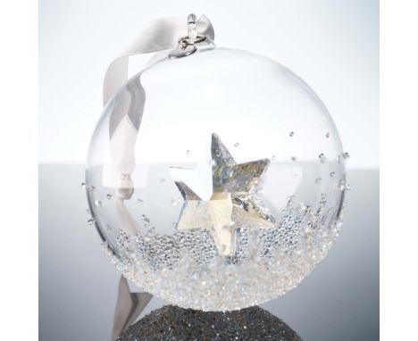 Annual edition Christmas ball featuring an eye catching clear crystal star set within a hand blown glass globe. Accented with