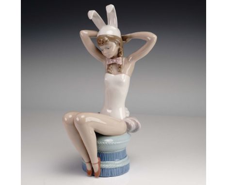 Issued in 1982 and designed by Salvador Debon, this Lladro porcelain figurine captures a whimsical moment as a young girl, dr