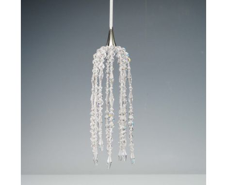 A clear crystal ornament designed to replicate the ornaments used on the Great Tree; for Marshall Field's. Features an elegan