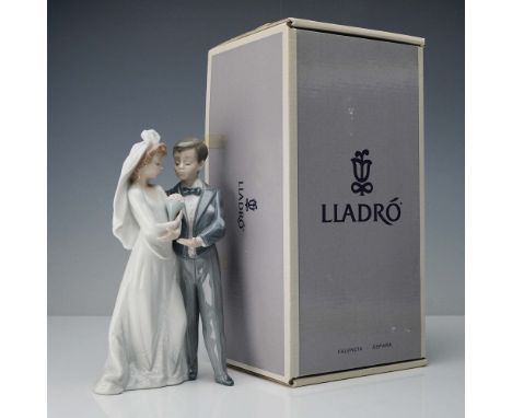 Depicting a bride and groom on their wedding day, the figurine is rendered in Lladro's signature glossy finish. The bride is 