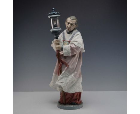 Glazed finish sculpture portraying a solemn sacristan in ceremonial robes, holding a tall processional lantern with reverent 