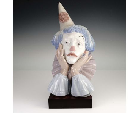 Lladro porcelain figurine 5129 presents a poignant bust of a sad jester with a wistful expression, captured in a glossy paste