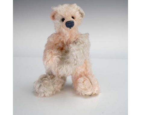 This charming artist teddy bear named Scrumpy is a rare early creation by renowned designer Deb Canham. Crafted in a distinct