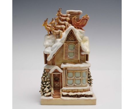 This charming collectible sculpture depicts a nostalgic winter scene features a snow covered Victorian style house with metic