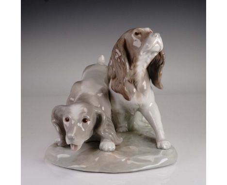 This charming Lladro porcelain figurine, model 1000442, titled Couple of Cocker Spaniels, beautifully captures the gentle dem