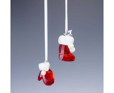 A charming 2-piece set of Swarovski crystal holiday ornaments featuring a ruby red mitten and a coordinating stocking, both a