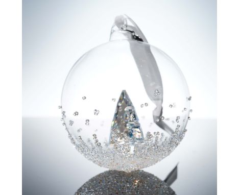 Annual edition Christmas ball featuring a dazzling clear crystal Christmas tree set within a hand-blown glass globe. Accented