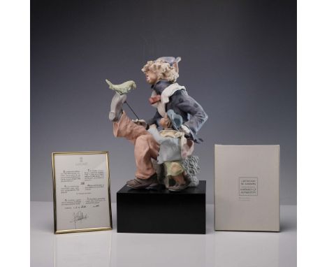 A limited edition goyesca finish figure depicting a whimsical clown balancing a parrot on his elevated shoe while a young boy