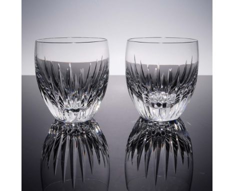 A pair of finely crafted Baccarat crystal tumblers featuring a radiant vertical cut pattern that captures and reflects light 