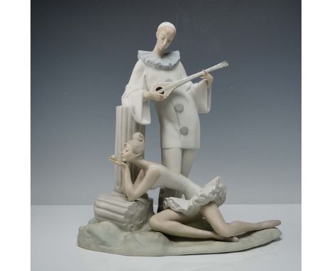 This elegant porcelain figurine captures a poetic moment between a delicate ballerina and the wistful figure of Pierrot, who 