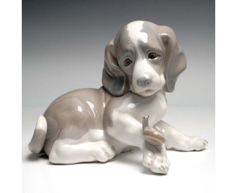 Handmade in Spain, this endearing Lladro porcelain figurine titled Dog and Snail (Spanish name: Perro Caracol Grande) was scu