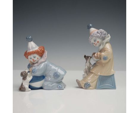 This endearing pair of Lladro porcelain figurines features two joyful Pierrot clowns engaging with playful pups. The taller p