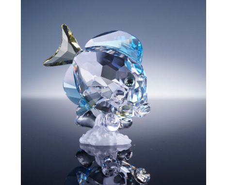 This vibrant Swarovski crystal figurine depicts a Blue Tang fish in stunning aquatic hues, featuring a faceted clear body wit