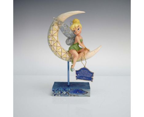 Charming and full of character, this Disney Traditions figurine features Tinker Bell gracefully seated on a sculpted crescent