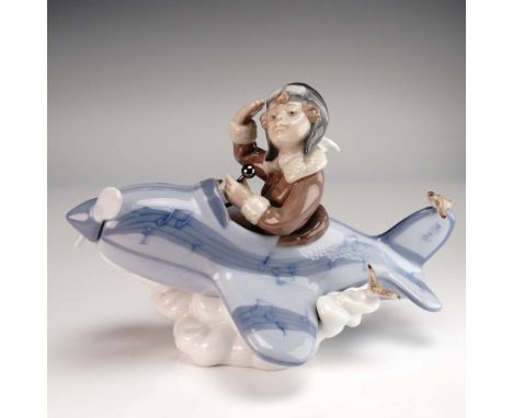 This Lladro porcelain figurine titled Over the Clouds (Item No. 1005697) features a whimsical child aviator soaring atop a pa