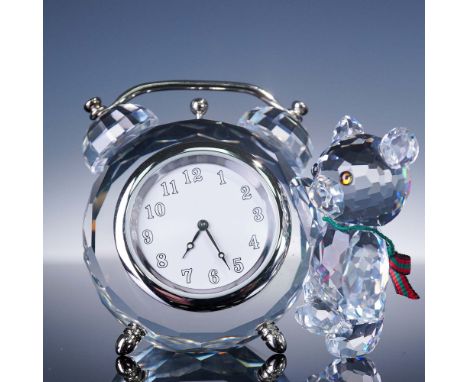 This charming Swarovski Kris Bear figurine features a faceted crystal bear adorned with a festive red-and-green ribbon scarf,