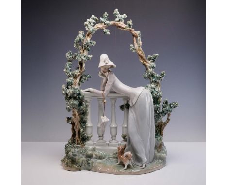 Glazed finish porcelain sculpture depicting a graceful lady in a flowing gown and wide brim hat, resting thoughtfully against