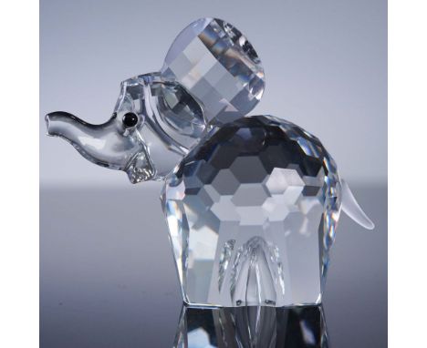 This charming Swarovski Silver Crystal elephant figurine features precision-cut clear crystal with faceted surfaces, large ea