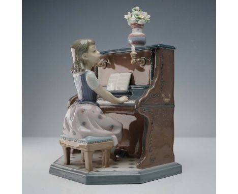 This charming Lladro porcelain figurine, number 5462, titled Practice Makes Perfect, was crafted in 1987 in Valencia, Spain, 